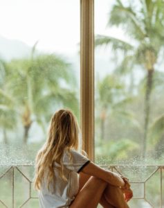 Finding help woman looking out on rainy day